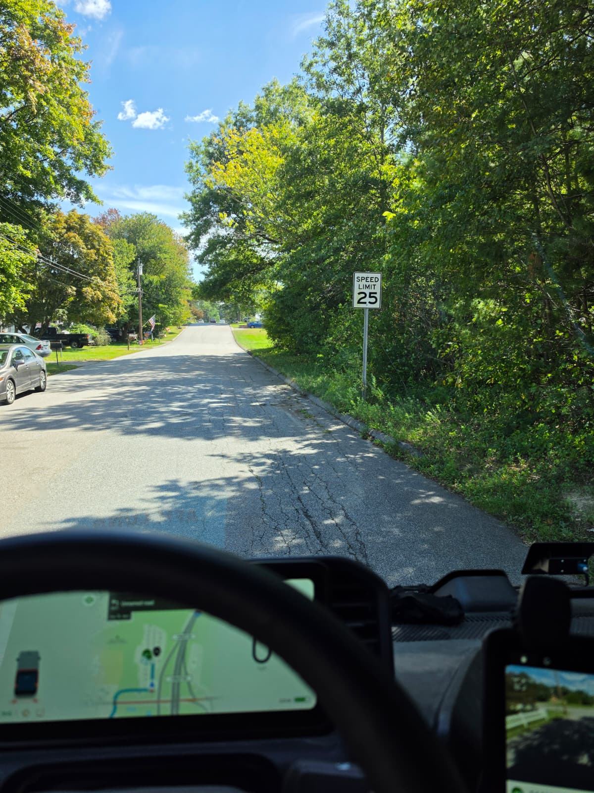 A Connecticut street seen from the driver's seat of a delivery van